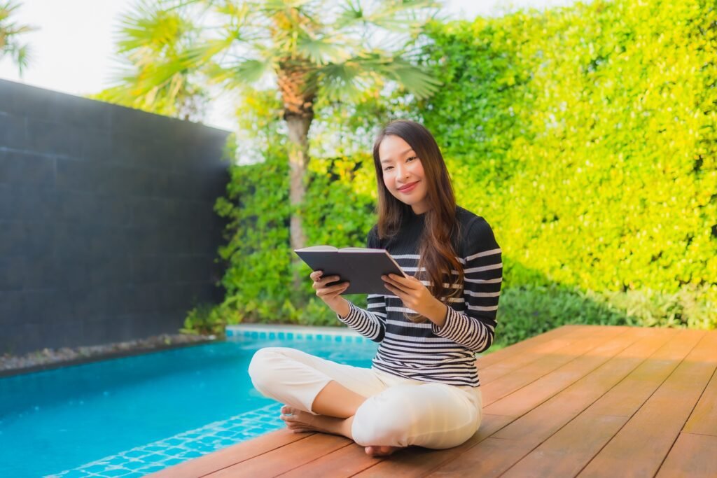Smart Pool Technology in 2026: How Automation is Changing Pool Maintenance | Affordable Pool Repair Woman relaxing by an outdoor swimming pool at a hotel resort after renovation