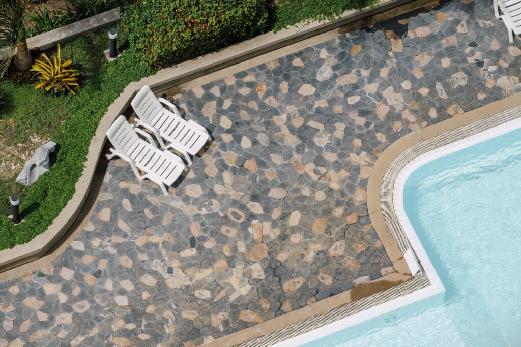 Complete Guide to Pool Finishes: Quartz vs Pebble vs Plaster | Affordable Pool Repair Swimming pool top view showing clear blue water for pool renovation planning in New England